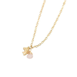 Children's gold necklace featuring a dainty rose quartz bead and brass unicorn charm by forai.